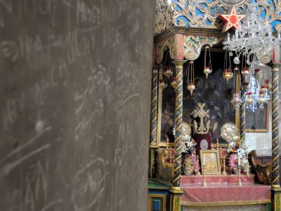 Adorned altar next to graffiti