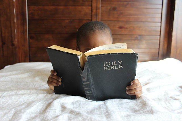 African child reading from a Bible